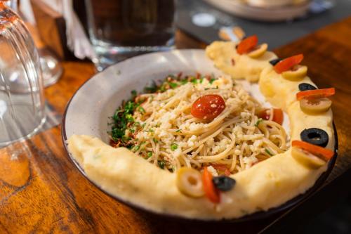 a plate of food with a pizza on a table at Solo Inn By Hawk Hospitality in Cochin