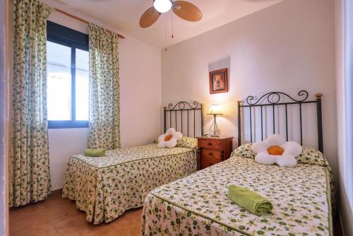 a bedroom with two beds with stuffed animals on them at Apartamento Atlanterra Playa in Zahara de los Atunes
