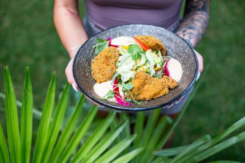 a person is holding a plate of food at Mala Garden Design Hotel in Siófok