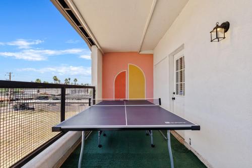 a ping pong table in a room with a balcony at Penthouse Free Parking Pool Table Private Balcony in Phoenix