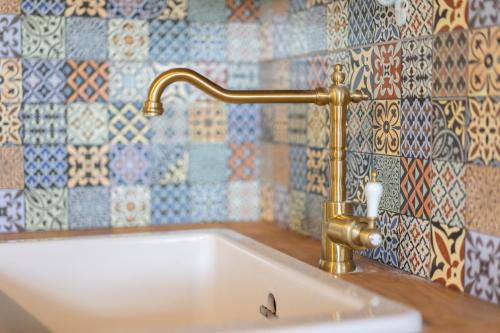 a bath tub with a brass faucet in a bathroom at Apartmány Skuteč in Skuteč