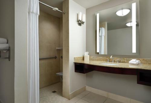 a bathroom with a sink and a mirror at Hilton Garden Inn Shreveport Bossier City in Bossier City
