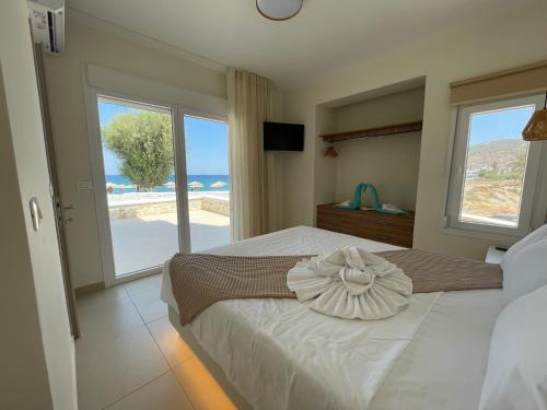 a bedroom with a bed with a flower on it at Tamaris Suites in Karpathos Town
