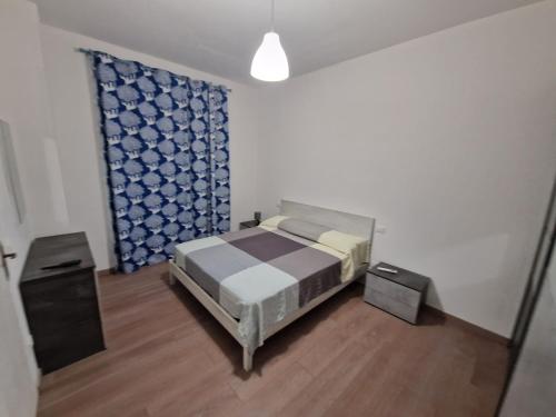 a bedroom with a bed and two night stands at Appartamento Achille in Pontassieve