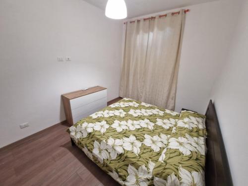 a bedroom with a bed with white flowers on it at Appartamento Achille in Pontassieve