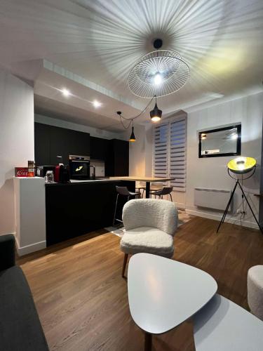 un salon avec deux chaises et une table dans l'établissement Appartement le flamboyant - WIFI - CENTRAL - COSY, à Aix-les-Bains