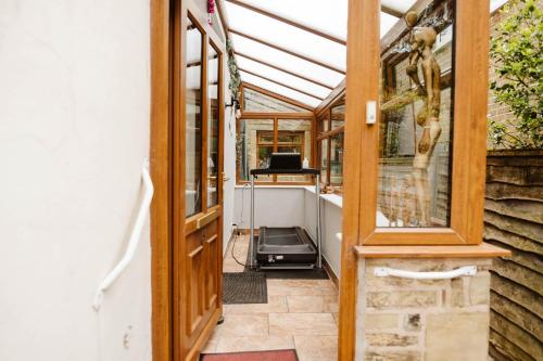 an internal view of a greenhouse with a glass door at Quirky comfort cottage in Haslingden