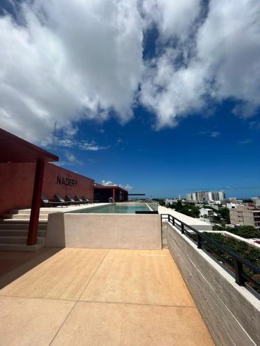 a swimming pool on the roof of a building at New Business Centric Loft with gym and pool in Cancún