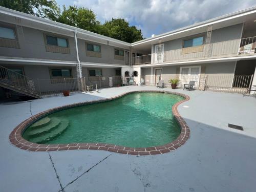 a swimming pool in front of a building at Two bedroom apt with desk washer dryer & pool in Baton Rouge