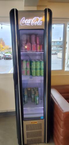 a cocacola soda refrigerator with drinks in it at Hotel Corvallis in Corvallis