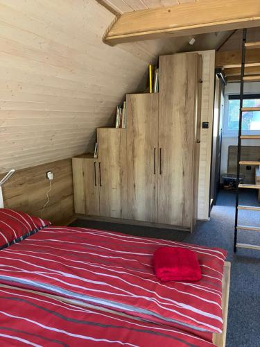 a bedroom with a large bed with wooden cabinets at Chata u Járy in Trojanovice