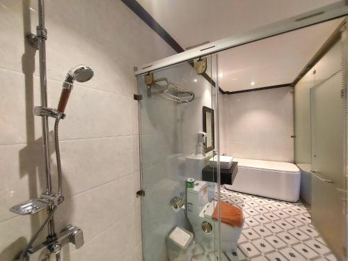 a bathroom with a shower and a toilet at Luang Prabang Meunna Hotel in Luang Prabang