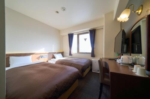 a hotel room with two beds and a desk at Minakuchi Century Hotel - Vacation STAY 35285v in Koka