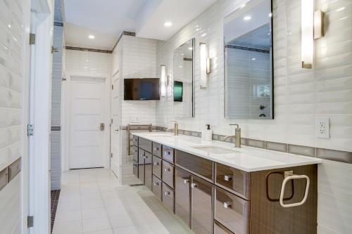 a bathroom with a sink and a mirror at Furnished Patio Family-Friendly Cape Cod Home! in Centerville