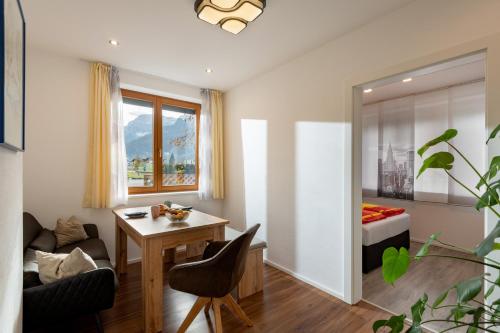 a living room with a desk and a bed at Ferienwohnung Weiss in Waidring
