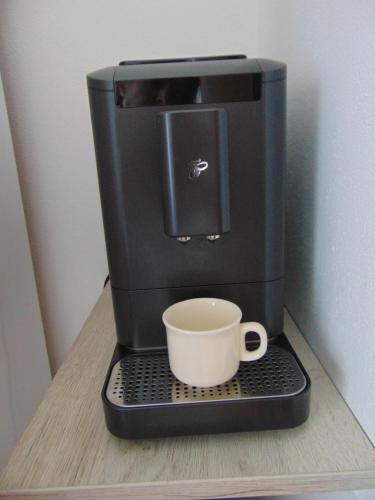 a coffee maker with a cup sitting on a counter at Apartmán u Jána in Ružomberok
