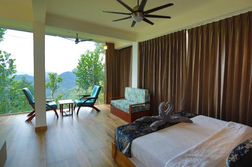 a bedroom with a bed and a table and chairs at Roots Munnar in Anachal