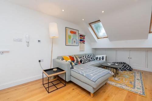 a living room with a couch and a table at The Old Wire Factory - 2 bed, Close to city centre, Fast wifi, comfortable home from home in Bristol