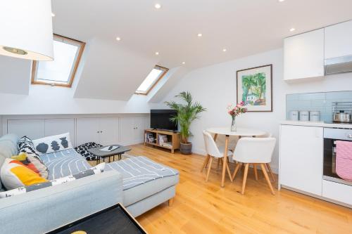 a living room with a couch and a table at The Old Wire Factory - 2 bed, Close to city centre, Fast wifi, comfortable home from home in Bristol