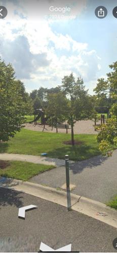 a view of a park with a park bench and trees at Pleasant, Enjoyable and Relaxing, Lower Level in Silver Spring