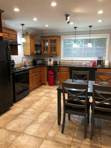 a kitchen with a table and a black refrigerator at 2 bedroom apartment next to LSU campus in Baton Rouge
