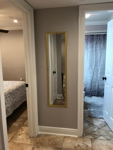 a mirror on a wall in a room with a bed at 2 bedroom apartment next to LSU campus in Baton Rouge