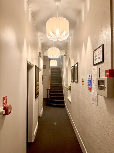 a hallway with a stairway with a hallwayngthngthngthngthngthngthngth at Kensington Gardens in London
