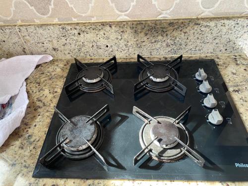 a stove top with four burners on top of it at Pousada Lagoa Flat in Morro de São Paulo