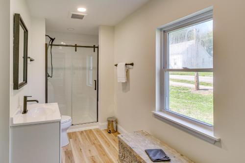 a bathroom with a toilet and a sink and a window at Vino Villa Wine Country Gem Patio and Grill in Defiance