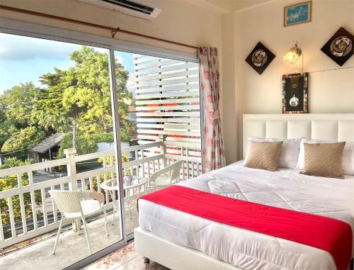 a bedroom with a bed and a balcony at Home One Love Ayutthaya GH in Phra Nakhon Si Ayutthaya