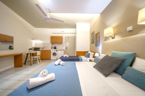 a room with a large bed with towels on it at RODI BLUE apartments in Amoudara Herakliou
