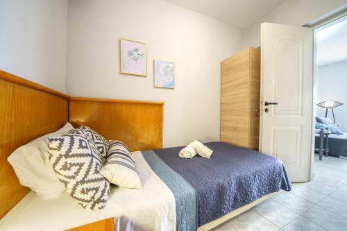 a bedroom with a bed with a wooden headboard at RODI BLUE apartments in Amoudara Herakliou