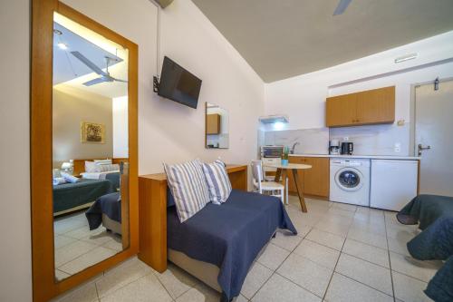a room with a kitchen and a living room at RODI BLUE apartments in Amoudara Herakliou