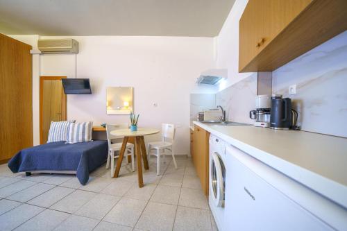 a kitchen with a table and a counter top at RODI BLUE apartments in Amoudara Herakliou