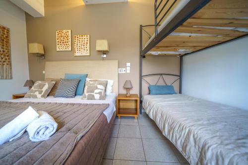 two beds sitting next to each other in a room at RODI BLUE apartments in Amoudara Herakliou