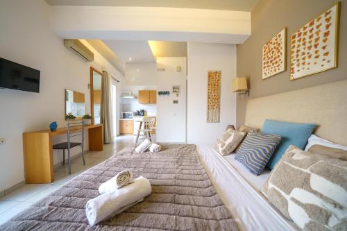 a bedroom with a large bed with towels on it at RODI BLUE apartments in Amoudara Herakliou