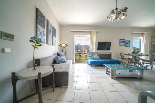 a living room with a couch and a table at RODI BLUE apartments in Amoudara Herakliou