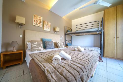 a bedroom with a large bed with towels on it at RODI BLUE apartments in Amoudara Herakliou