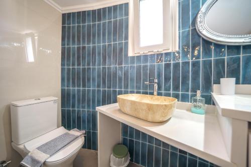 a bathroom with a sink and a toilet at RODI BLUE apartments in Amoudara Herakliou