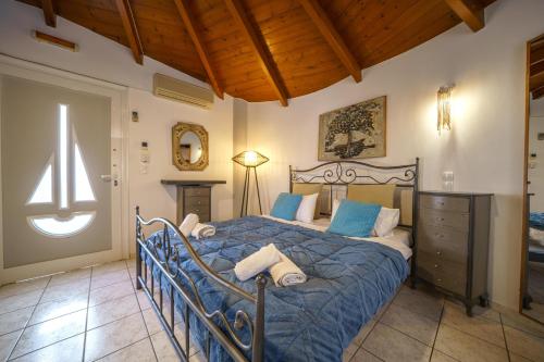 a bedroom with a bed with a blue comforter at RODI BLUE apartments in Amoudara Herakliou