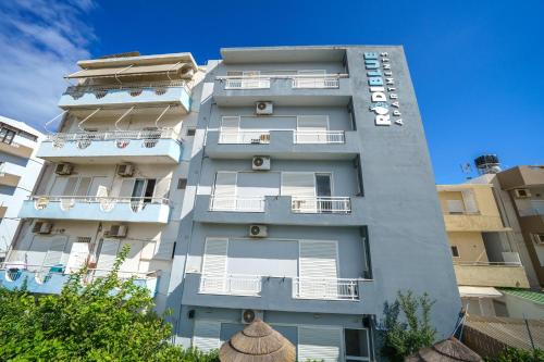 a tall white building with balconies on it at RODI BLUE apartments in Amoudara Herakliou
