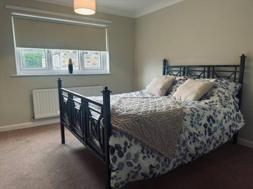 a bedroom with a bed with a comforter and pillows at The Jennings in Normanby