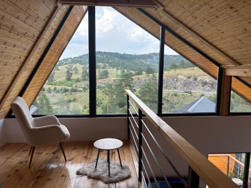 a room with a chair and large windows at Vita Abies in Vodice