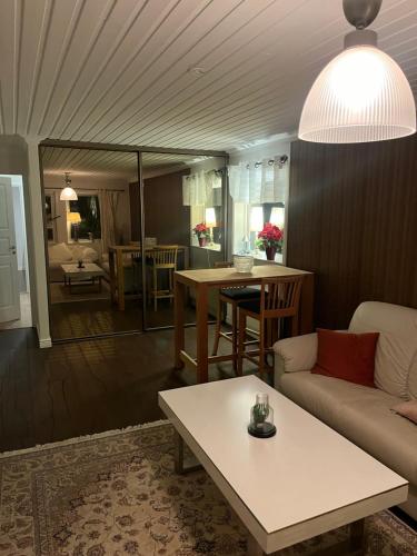 a living room with a couch and a table at Domarringen Guest house in Gävle