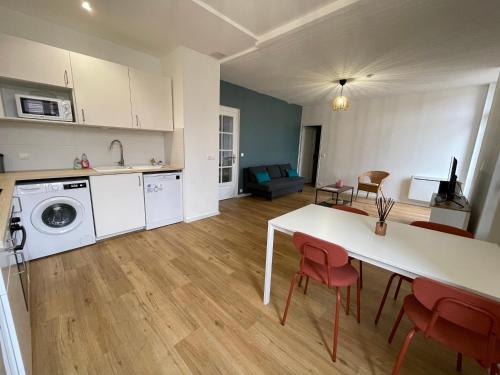 Capdenac-GareにあるLe Republicのテーブルと椅子のあるキッチンとリビングルーム