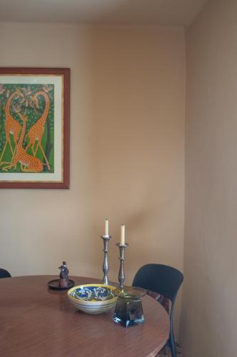 a dining room table with two candles on top at The Winemaker's House - La Collina La Casa in Casa Berta