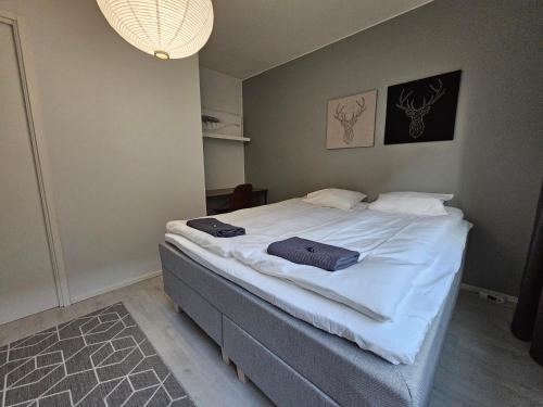 a bedroom with a bed with two towels on it at Tampere Central Cozy Stay - Two-room apartment and fully equipped FREE PARKING in Tampere
