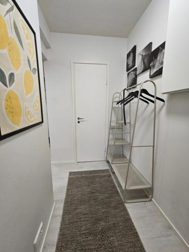a hallway with a stairwell with a glass shelf at Tampere Central Cozy Stay - Two-room apartment and fully equipped FREE PARKING in Tampere