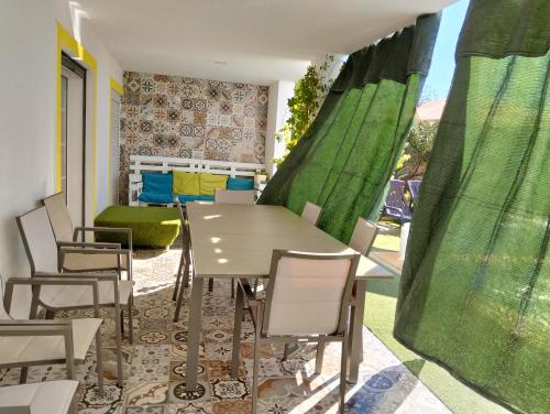 a dining room with a table and chairs at Ground Floor Room Sofia's Happy House - Almodôvar Ourique in Aldeia dos Fernandes