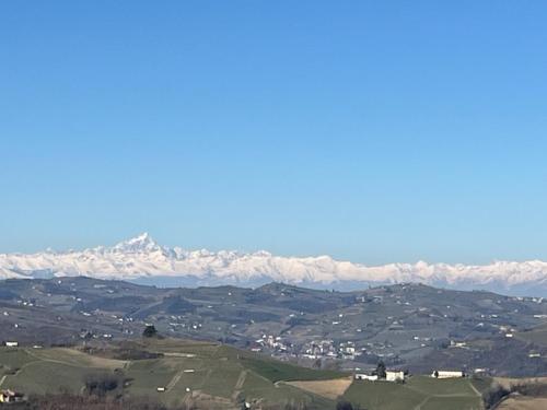 a view of a mountain range with snow covered mountains at The Winemaker's House - La Collina La Casa in Casa Berta